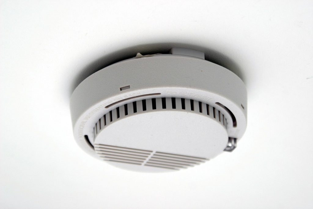 a smoke detector to illustrate the importance of health and safety in short-term holiday rentals