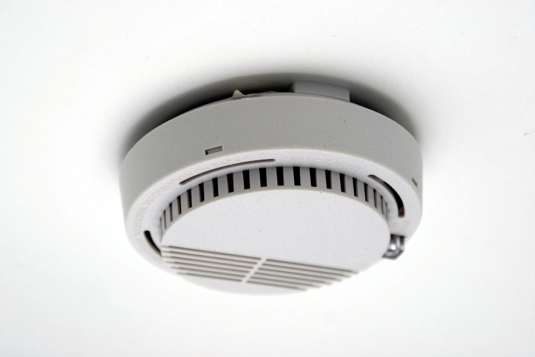 a smoke detector to illustrate the importance of health and safety in short-term holiday rentals